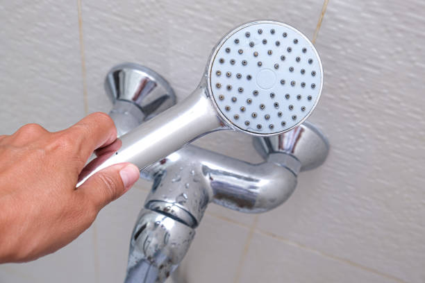 istock Hand holding clean shower head and a water tap on background, everyday routine, self hygiene concept 2178414164