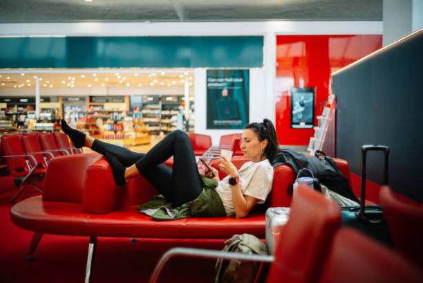 istock Reading stuff on the phone while waiting for the flight at the airport 2178414414