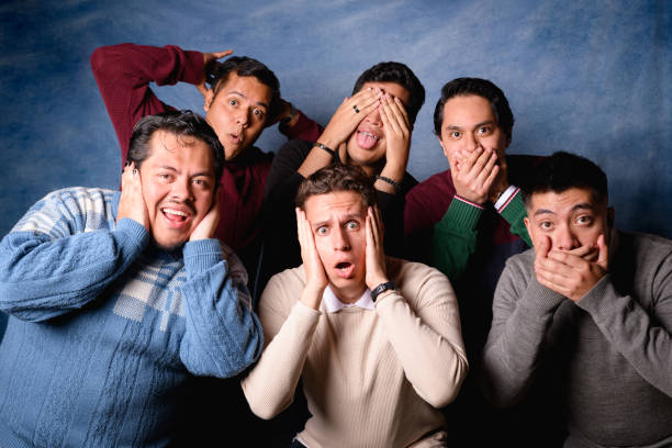 Group of 6 young and diverse men with sweater on blue background in 90's yearbook style. Expression of surprise