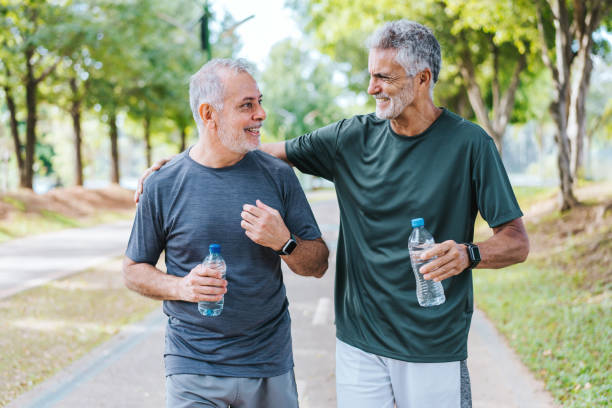 istock Senior friends walking in public park 2178416328