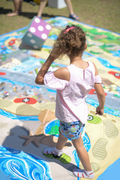 Toddler girl walking on playground board