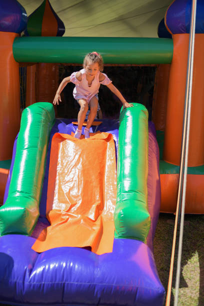 girl child playing on inflatable slide