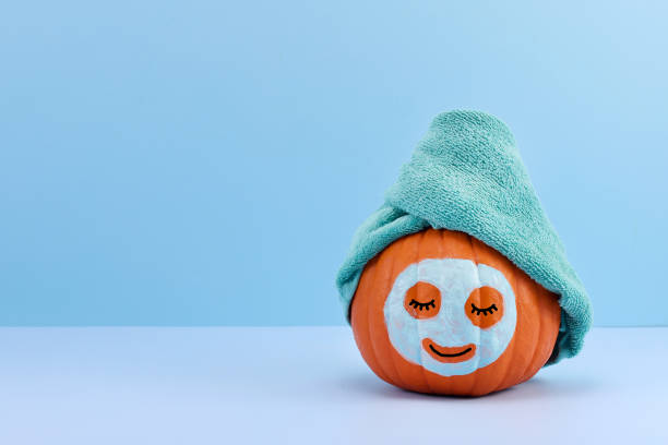 istock Relaxed Pumpkin. A pumpkin with a towel and face mask 2178422922