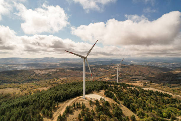 istock Wind turbines in forest area in cloudy weather. renewable energy sources 2178424333