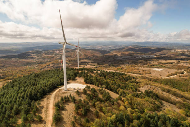 istock Wind turbines in forest area in cloudy weather. renewable energy sources 2178424411