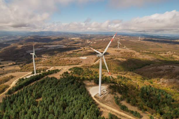 istock Wind turbines in forest area in cloudy weather. renewable energy sources 2178424489
