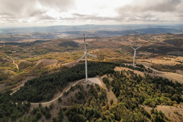 istock Wind turbines in forest area in cloudy weather. renewable energy sources 2178424691