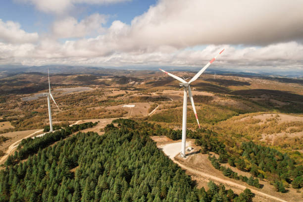 istock Wind turbines in forest area in cloudy weather. renewable energy sources 2178425211