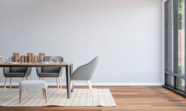 istock A side view of a modern almost empty dining room with a dining table and upoholstered chairs with decoration, a garden view through windows in the background 2178426331
