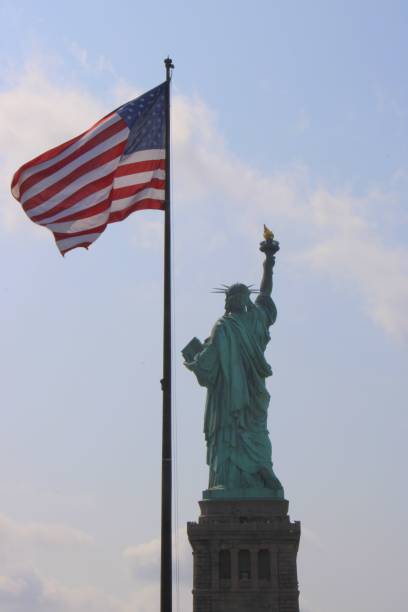 istock Statue of Liberty and American Flag 2178426415
