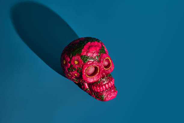 The skull is a symbol with deep roots in esoteric practices, representing mortality and transformation. In some cultures, it is believed to have protective powers or be used in rituals. Dark metallic and golden colours
