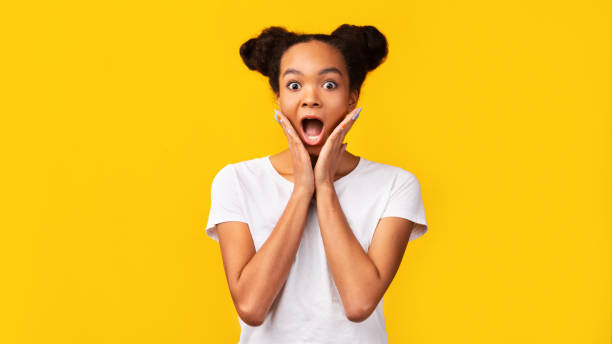 istock Amazed black girl screaming and holding cheeks 2178427905