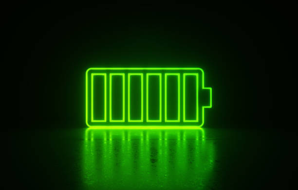 Glowing green full battery symbol on black background. Horizontal composition with copy space. Battery charger concept.