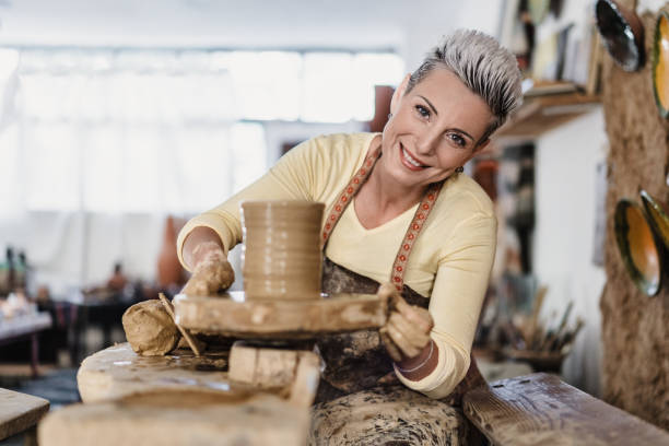 istock Young female artist creating a clay flower pot 2178428370
