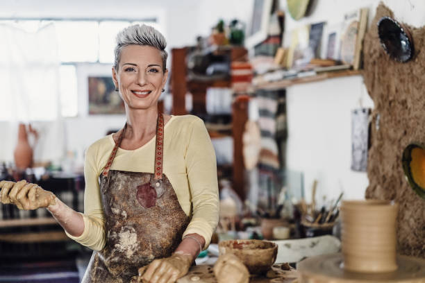 istock Female artist working on potters wheel in her studio 2178428385