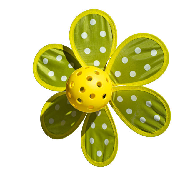 Vibrant toy pinwheels for children spinning in the breeze, colorful decoration outdoors symbolizing joy, childhood play and happy summer atmosphere