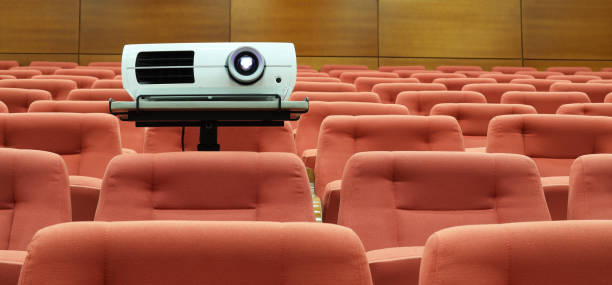 istock Video projector among empty seats in lecture room concept photo. Lecturer space scene 2178429385