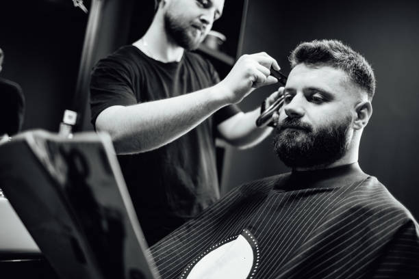 istock A man is getting his hair cut by another man 2178430124