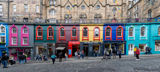 Edinburgh, Scotland - June 13, 2024: Colorful shops line Victoria Street, a picturesque and winding cobblestone lane in Edinburgh's Old Town.