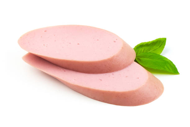 istock Fresh Boiled sausage slices with basil leaves, isolated on white background. 2178431469