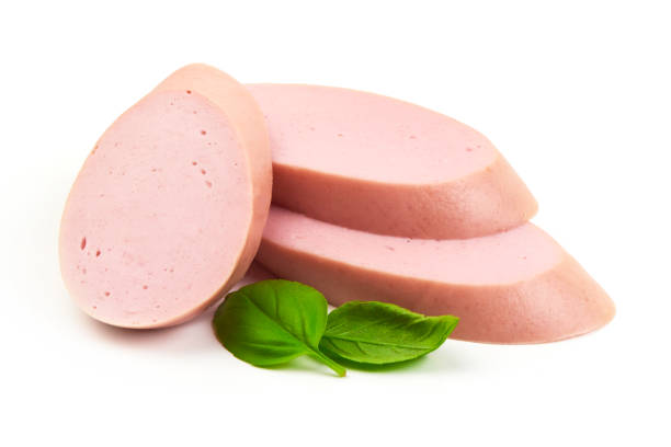 istock Fresh Boiled sausage slices with basil leaves, isolated on white background. 2178431471