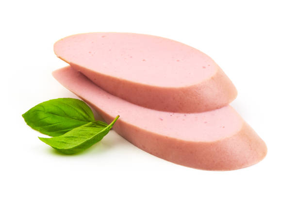 istock Fresh Boiled sausage slices with basil leaves, isolated on white background. 2178431472
