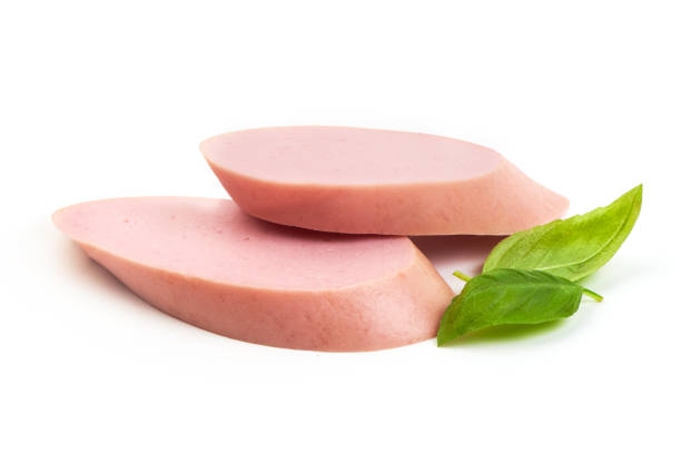 istock Fresh Boiled sausage slices with basil leaves, isolated on white background. 2178431504