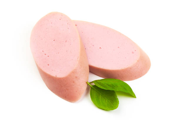 istock Fresh Boiled sausage slices with basil leaves, isolated on white background. 2178431508