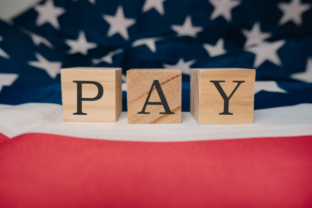 istock Wooden block with the word pay written on it 2178431564