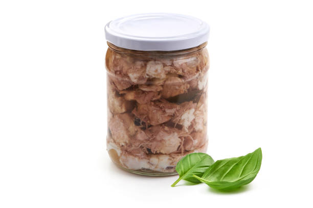 istock Canned meat in a glass jar with basil leaf, isolated on white background. 2178431972