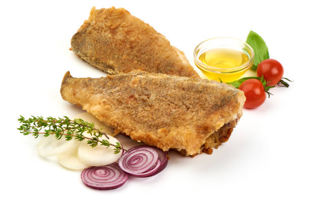 Hot fried fish with vegetables, isolated on white background