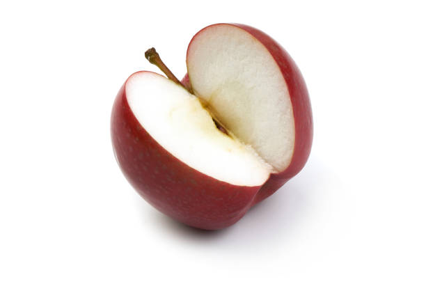 Red apple cut in half isolated on white background.
