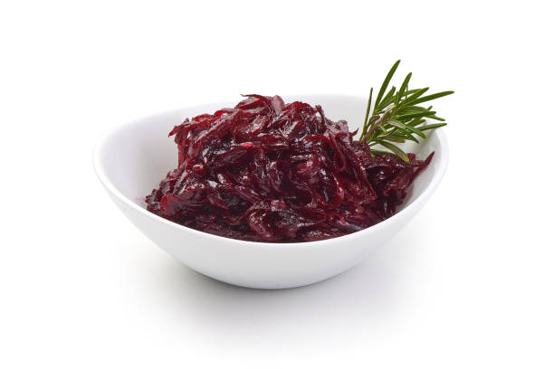 Bowl full with grated beets with herbs. Isolated on a white background.