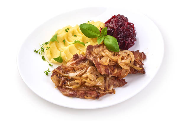 Escalope with fried onion with mashed potatoes and grated beet, isolated on white background. Close-up