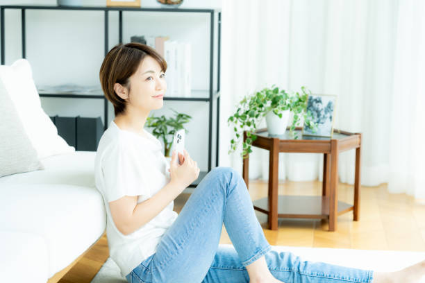 istock Middle-aged woman operating a smartphone in the room 2178434352