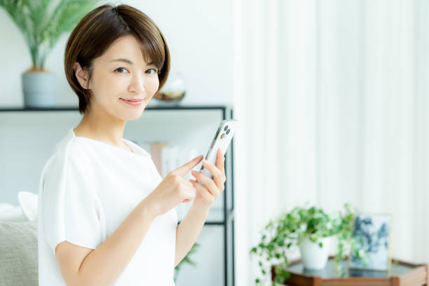 istock Middle-aged woman operating a smartphone in the room 2178434364