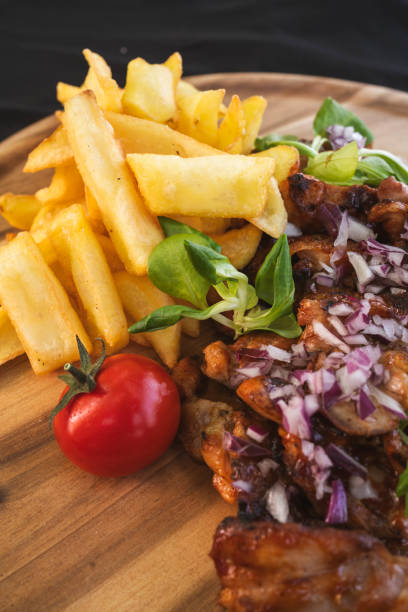 istock Marinated chicken, fries and cherry tomato close up vertical 2178435528