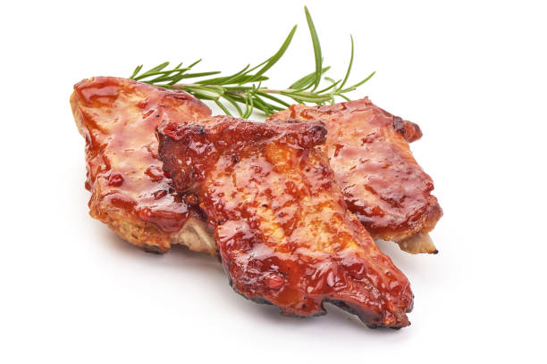 istock Delicious spicy marinated ribs in a bbq or tomato sauce with herbs, isolated on a white background. Close-up. 2178436098