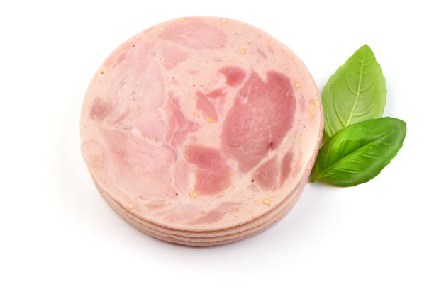 Bulgarian Pork Ham slices with basil leaves, close-up, isolated on a white background