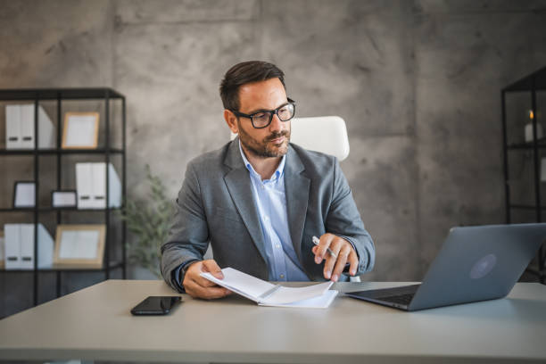 istock confident businessman work on new project on notebook in modern office 2178437071