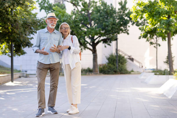 istock Happy senior couple standing in park, embracing and chatting 2178442071