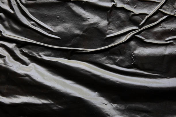 istock black crumpled and creased plastic poster texture background 2178442144
