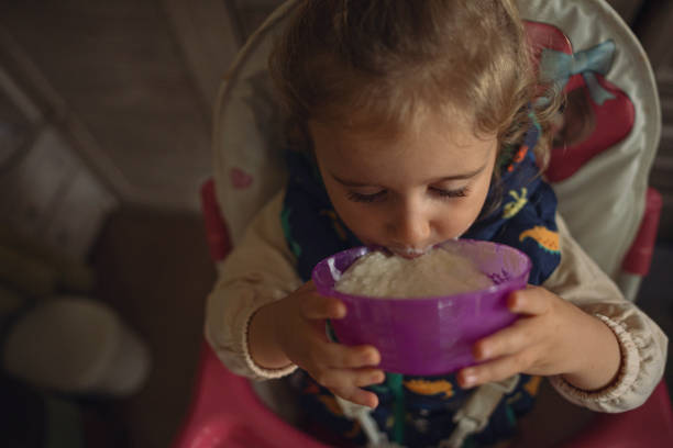 istock Kids Mischief. Child in High Chair Eats Alone. Doing Mess. 2178442156