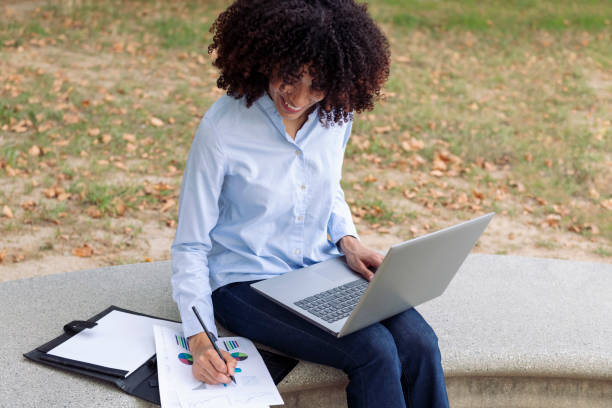 istock female entrepreneur working remotely in park 2178442398