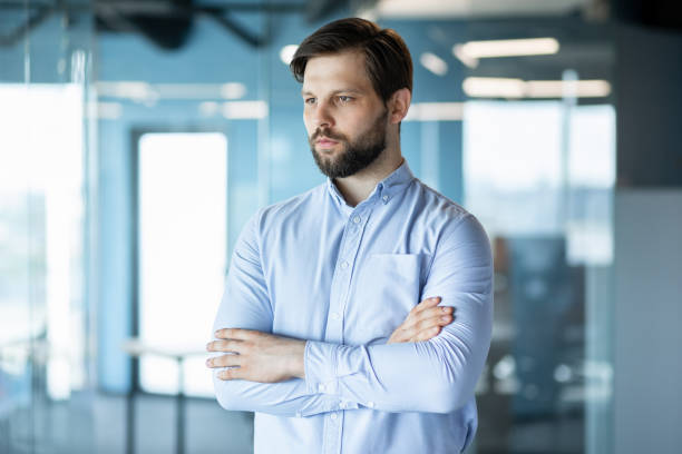istock Confident Businessman Standing in Modern Office Environment 2178442553