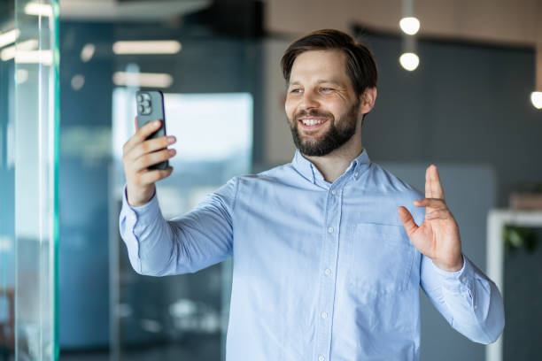 istock Smiling Professional Man Video Call in Office Environment 2178442554