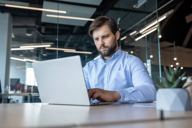 istock Focused Businessman Using Laptop in Modern Office 2178442567