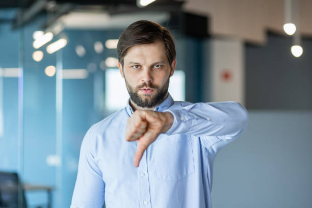 istock Businessman Showing Thumbs Down Gesture in Modern Office 2178442572
