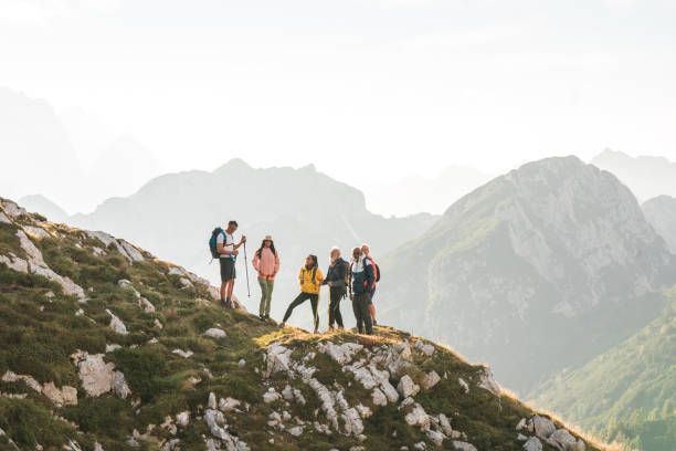 istock Diverse Friends Hiking with Backpacks and Poles 2178443501