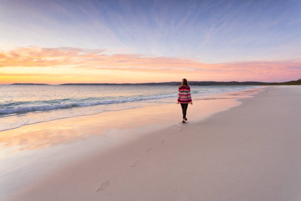 istock Woman morning walk along the beach sunrise sky 2178444301